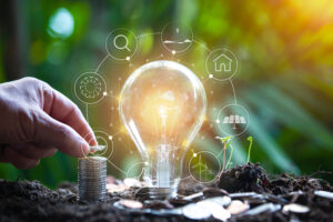 hand holding light bulb against nature, icons energy sources for renewable,
